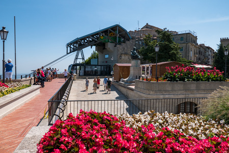 SAN MARINO, REPUBLIC OF SAN MARINO - 6 AUGUST 2018: Arrival of the San Marino cableway while tourists admire the spectacular view over the valleyのeditorial素材