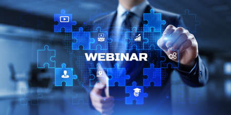 Webinar online learning education concept. Businessman pressing button on screen.の写真素材
