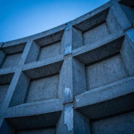 Close-up of a concrete wall with a blue sky in the background