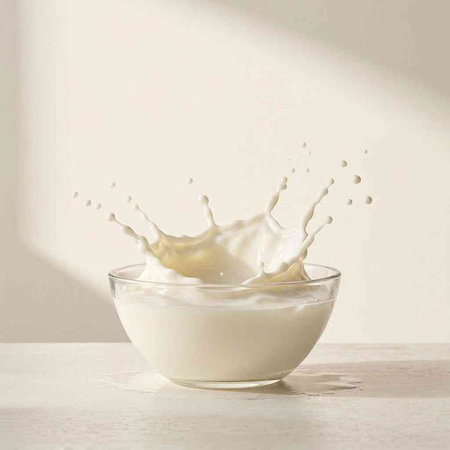 Milk splash in a glass bowl on a white background. 3d rendering
