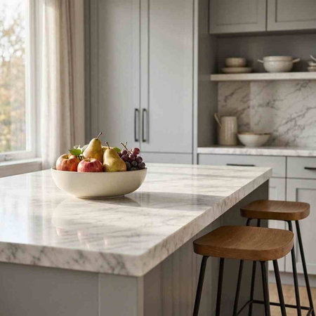 Fresh fruits on a white marble countertop in a modern kitchen.