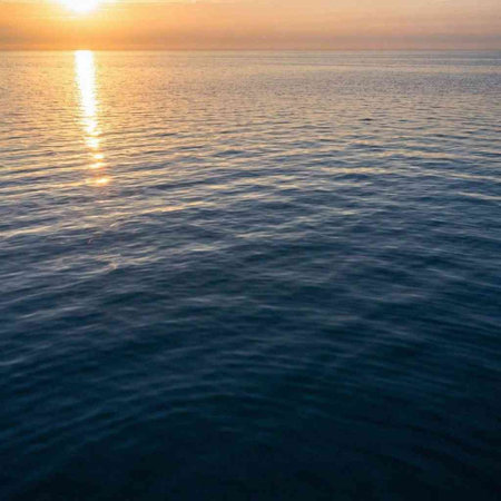 Sunset on the sea. The sun is reflected in the water.
