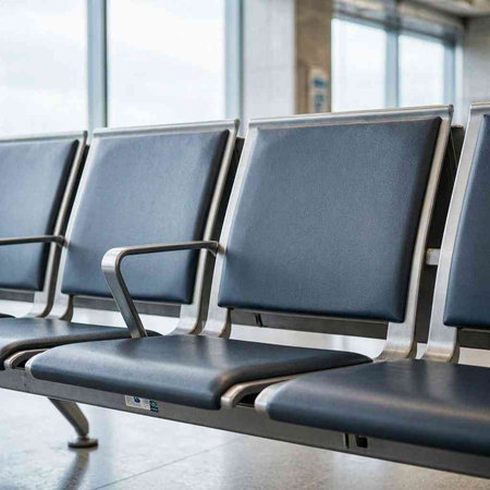 Waiting area in the airport terminal. Row of empty seats.