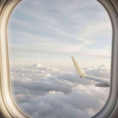 View from the airplane window on clouds and sky from the porthole