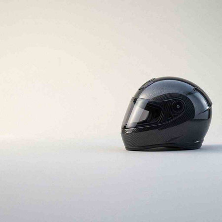 Black motorcycle helmet on a white background. Side view. Copy space.
