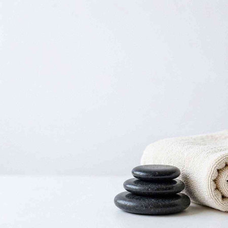 Spa stones and towel on a white background. Spa concept.