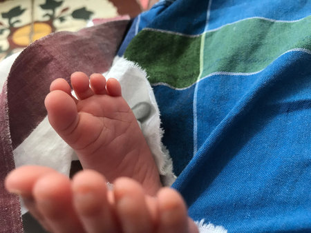 Legs of an Infant closeup image and parents are happy for the new born baby with healthy and make...