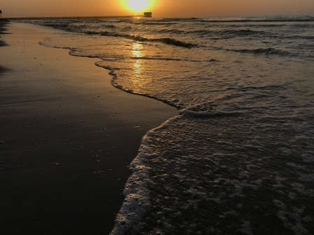 Evening Sunset at the beach muscat with background of running waves of ocean towards oman peninsulaのeditorial素材