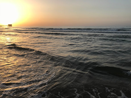 Evening Sunset at the beach muscat with background of running waves of ocean towards oman peninsulaのeditorial素材