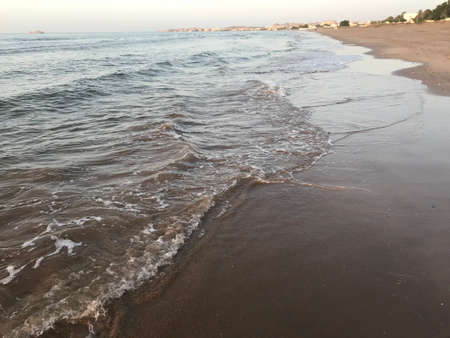 Evening Sunset at the beach muscat with background of running waves of ocean towards oman peninsulaのeditorial素材