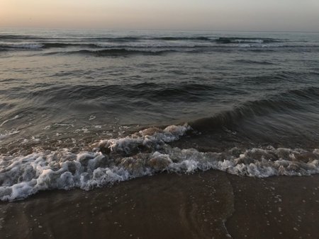 Evening Sunset at the beach muscat with background of running waves of ocean towards oman peninsula