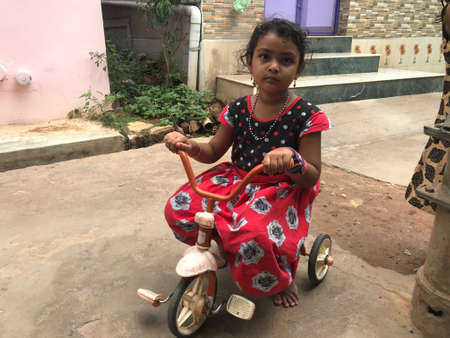 A girl riding cycle alone in an fine evening and feeling bored while other children not available to have game and funのeditorial素材