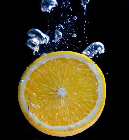 Orange and splash waterの写真素材