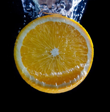 Orange and splash waterの写真素材