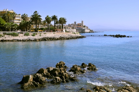 Rocky coast of Antibes in southeastern France, mediterranean area, with the old town in the backgroundの写真素材