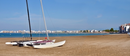 Panoramic photo of catamarans on the beach of Roses, or Rosas, commune on the Costa Brava at northeastern Catalonia in Spainの写真素材