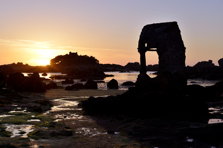 Sunset in the beach of Ploumanac'h with the famous old Oratory Saint-Guirec building at low tide on the Pink Granite Coast (pink granite coast in french). Ploumanac'h is a village of Perros-Guirec in the region Brittany in the C?'tes-d'Armor department inの写真素材