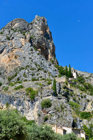 Moustiers-Sainte-Marie and Notre-Dame-de-Beavoir chapel in the mountain. Moustiers-Sainte-Marie is a commune in the Alpes-de-Haute-Provence department in southeastern Franceの写真素材
