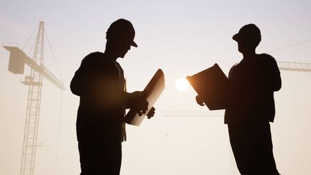 Construction Engineers Talk with Cranes in the Back 3D renderingの写真素材