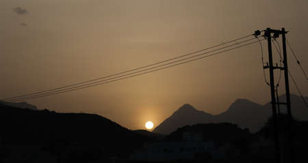 Sunset and electricity polesの写真素材