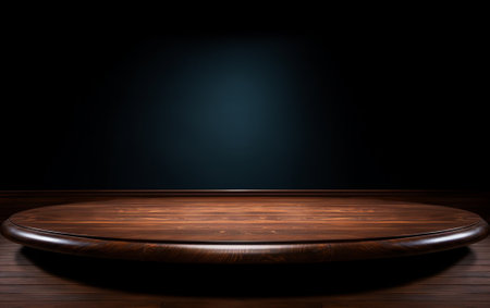 An empty wooden table for presentation with a dark background and isolated recessed lightingの素材