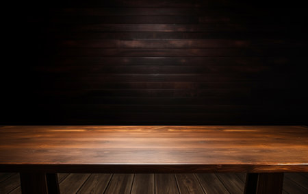 An empty wooden table for presentation with a dark background and isolated recessed lightingの素材