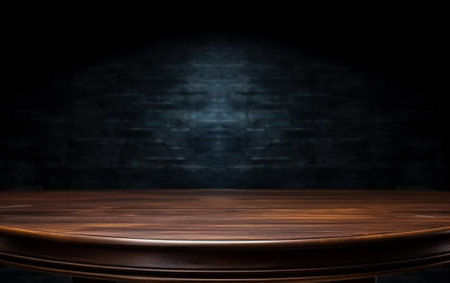 An empty wooden table for presentation with a dark background and isolated recessed lightingの素材