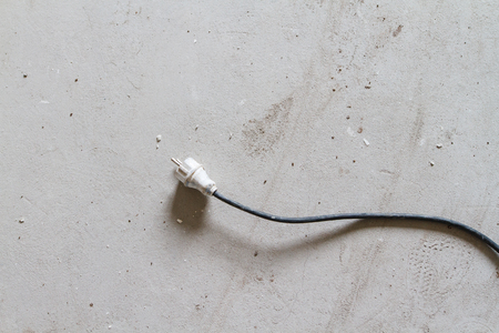 plug from the power tool on the concrete floor of a new buildingの写真素材