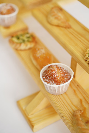Baked pies and cakes on wooden shelvesの写真素材