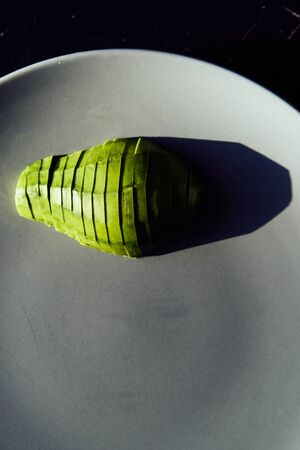food background with fresh organic avocado on plate, top view, copy spaceの写真素材