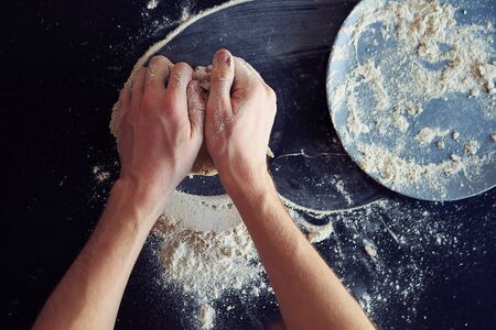 Unrecognizable male cook. A male baker is cooking bread. Making bread.の写真素材