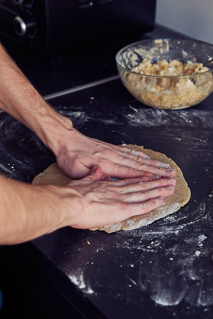 Unrecognizable male cook pizza. The process of making pizza