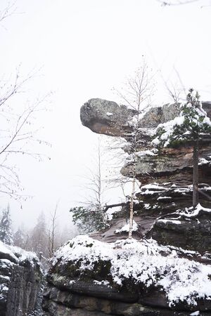 Snow-covered rocks, trekking, mountains, friends on a trekの写真素材