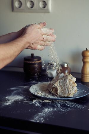 Unrecognizable male cook. A male baker is cooking bread. Making bread.の写真素材