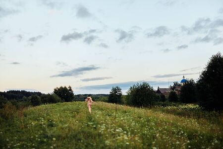  Girl running on a lush green field. High quality photoの写真素材