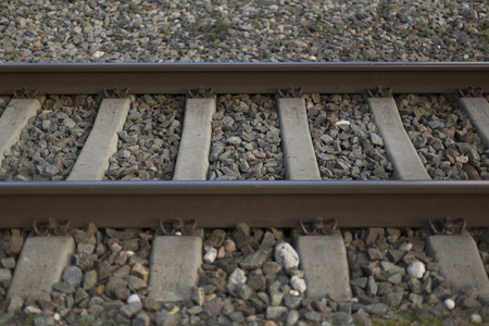 Rusty rails and gray crushed stone closeup backgroundの写真素材