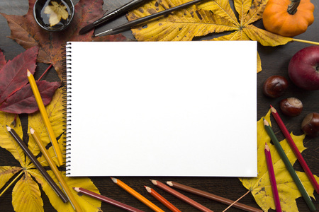Autumn composition with empty album and fallen leavesの写真素材