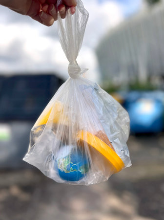 Globe in trash bag, concept of waste, climate change and global ecological problemsの写真素材