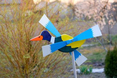 Wooden windmill in the shape of a flying duck in the garden.の写真素材