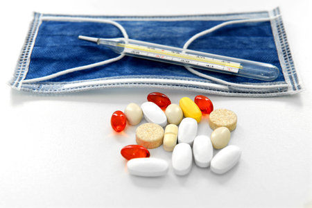 Many different medicines, mercury thermometer and medical mask