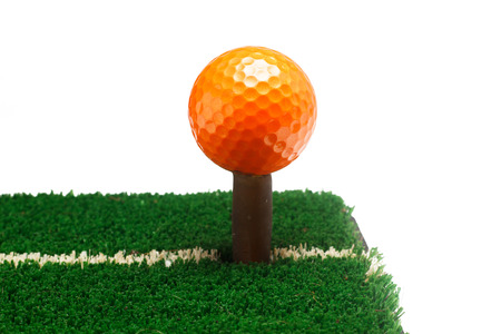 Orange golf ball on green grass selective focusの写真素材