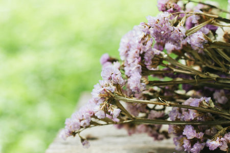 Closeup of dry flowers composition  wooden background.
