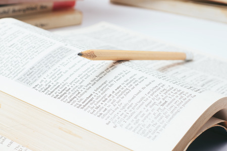 Close up  pencil with dictionary on white backgroundの写真素材