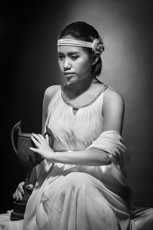 beautiful young woman with black hair and bright makeup. Fashion studio shot. Black and white imageの写真素材