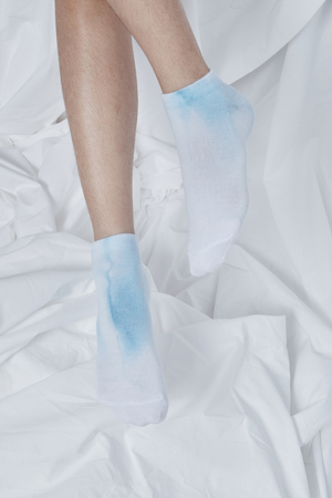 Woman wearing socks on white background.の写真素材