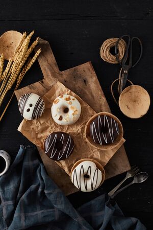 Different donuts on wooden table.の写真素材