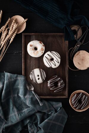 Different donuts on wooden table.の写真素材