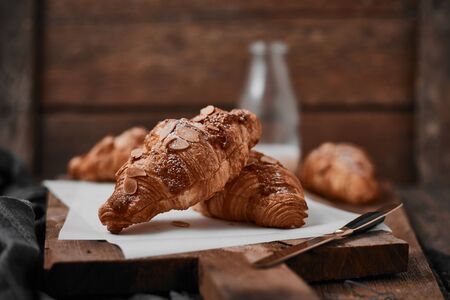 Almond croissant with custard filling on wood background.の写真素材