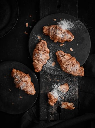 Almond croissant with custard filling on wood background.の写真素材