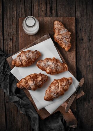 Almond croissant with custard filling on wood background.の写真素材